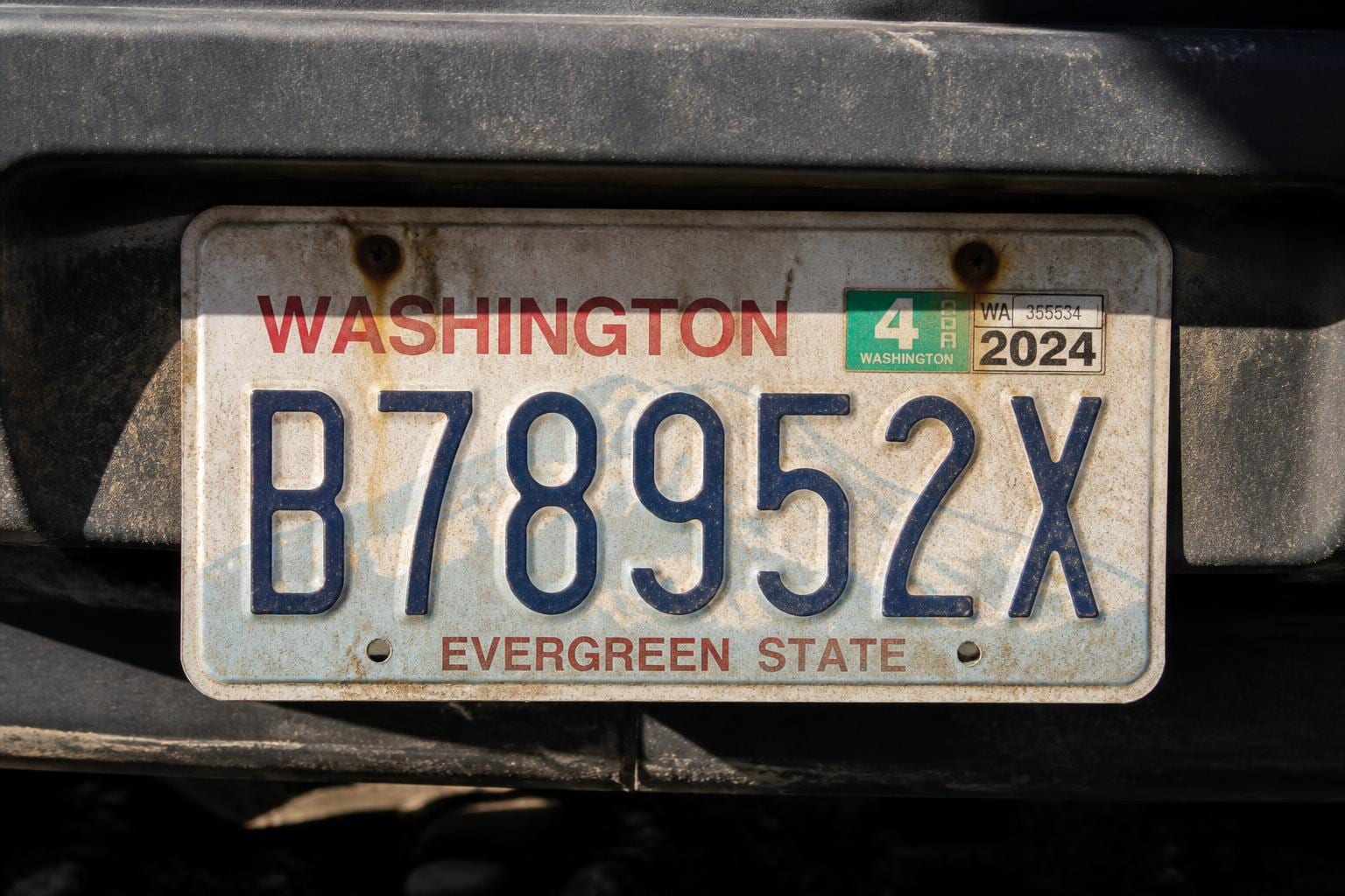 weathered vehicle license plate crop